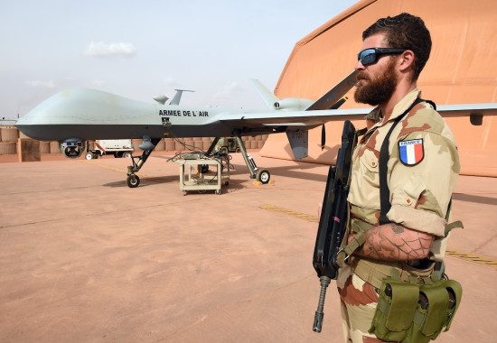 A French soldier involved in the regional anti-insurgent Operation Barkhane stands guard next to a Reaper drone at the French military air base in Niamey on March 14, 2016. 
Barkhane, which succeeded Serval in 2014, has at least 3,500 soldiers deployed across five countries -- Burkina Faso, Chad, Mali,  Mauritania and Niger -- to combat jihadist jihadist insurgencies. / AFP / PASCAL GUYOT        (Photo credit should read PASCAL GUYOT/AFP/Getty Images)