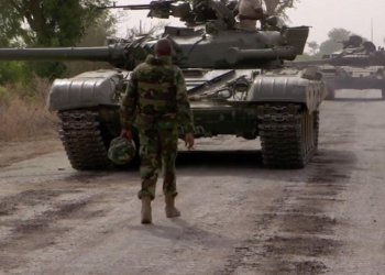 A Nigerian Army commander approaching a pair of T-72's coming back from forward reconnaissance in preparation for an armoured assault on a located terrorist base camp [720×480]