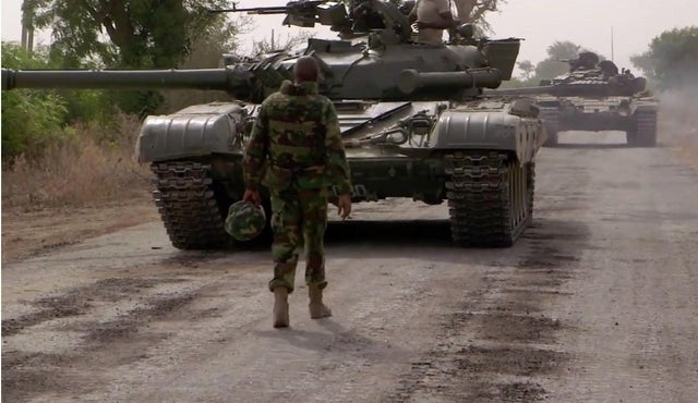 A Nigerian Army commander approaching a pair of T-72's coming back from forward reconnaissance in preparation for an armoured assault on a located terrorist base camp [720×480]