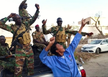 Sudanese citizens celebrate in Port Sudan, Sudan, following an announcement by the army that it had taken the city of Wad Madani, on January 11. (Ibrahim Mohammed Ishak/Reuters)