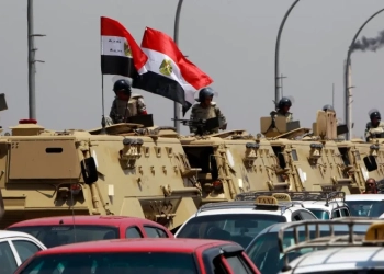 Egyptian army vehicles are parked near the Israeli embassy as protesters shout slogans against Israel in Cairo, August 21, 2011Photo by Amr Abdallah Dalsh/Reuters