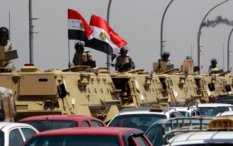 Egyptian army vehicles are parked near the Israeli embassy as protesters shout slogans against Israel in Cairo, August 21, 2011Photo by Amr Abdallah Dalsh/Reuters